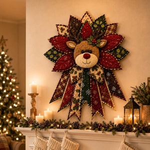 May include: A quilted fabric wall hanging featuring a central reindeer head surrounded by layered, star-shaped petals in red, green, and brown patterns. The reindeer has a tan face, dark brown antlers, and a red nose, mounted above a fireplace.