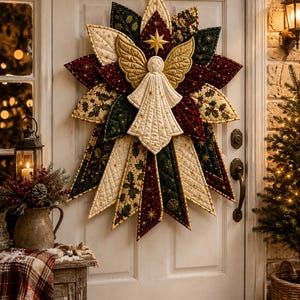 May include: A quilted fabric wall hanging shaped like a star with a central angel figure. The design features cream, dark red, and dark green fabric panels with holly and star patterns, accented by gold stitching and a small gold star at the top.