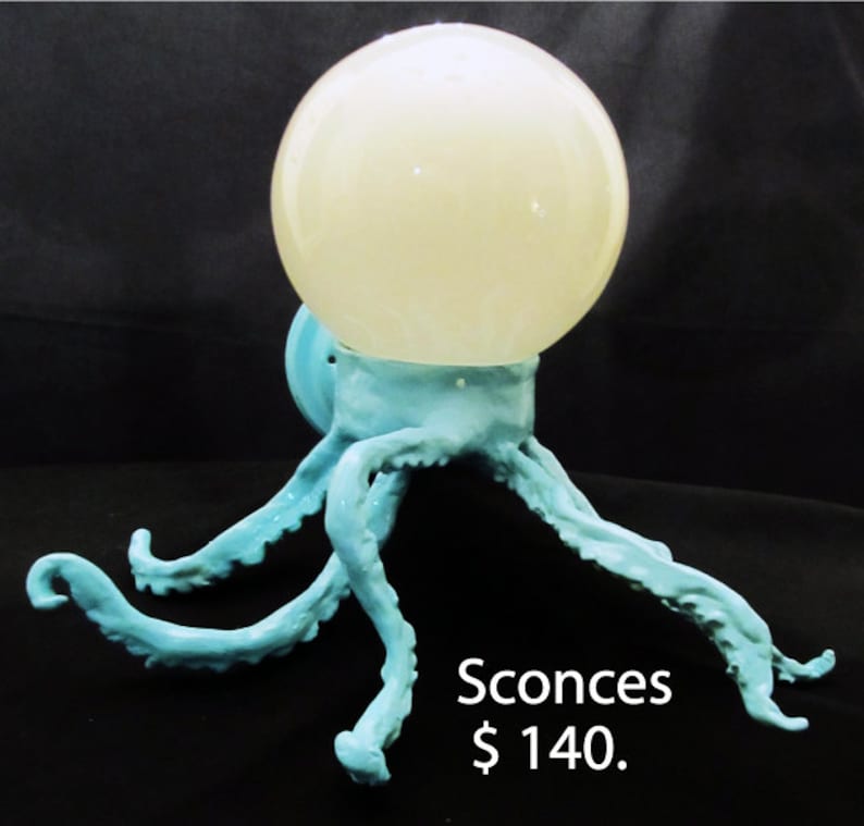 May include: A pair of blue ceramic wall sconces shaped like an octopus with a white globe light fixture. Sconces $140.