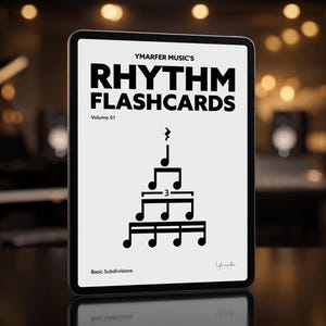 May include: A tablet displaying YMARFER MUSIC'S RHYTHM FLASHCARDS Volume 01. The screen features black text and a pyramid-shaped musical note diagram with a triplet bracket and a rest symbol, labeled Basic Subdivisions at the bottom.
