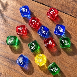 May include: A collection of twelve translucent, multi-colored gaming dice in red, blue, green, and yellow. The dice feature white printed numbers and shield icons with sword symbols, including positive and negative values ranging from -6 to +5.