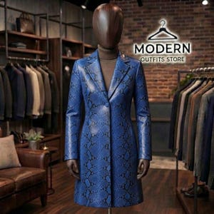 May include: A long-sleeved, knee-length coat featuring a vibrant blue and black snakeskin pattern. The coat has a notched lapel, a single-button front closure, and is displayed on a dark brown, featureless mannequin head and torso.