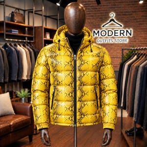 May include: A bright yellow puffer jacket with a black snakeskin pattern, featuring a hood with black drawstrings, a full-length black front zipper, and two zippered side pockets. The jacket is displayed on a dark brown mannequin torso.