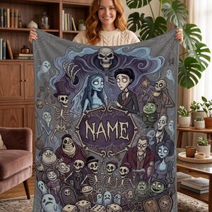 May include: A rectangular fleece blanket featuring a dark, animated-style illustration of various skeletal and ghostly characters surrounding a central purple frame with the word NAME printed in white, set against a gray background with spiderwebs.