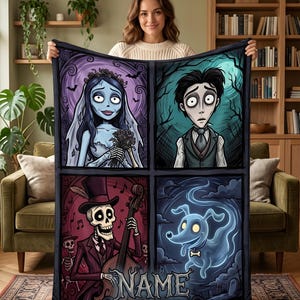 May include: A rectangular fleece blanket featuring a four-panel graphic illustration of characters from a gothic animated film. The design includes a bride, a groom, a skeleton playing a double bass, and a ghost dog, with the word NAME at the bottom.