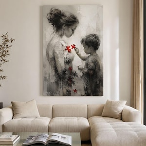 Peut inclure: Une impression d'art mural verticale représentant une illustration en niveaux de gris d'une personne aux cheveux en chignon et d'un jeune enfant. Le torse est composé de pièces de puzzle, et l'enfant place une pièce rouge vif sur la poitrine.