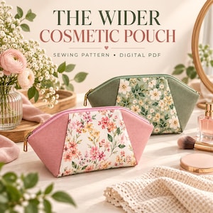 May include: Two cosmetic pouches with zipper closures, one in dusty pink with a floral center panel and one in sage green with a floral center panel. Text reads THE WIDER COSMETIC POUCH SEWING PATTERN • DIGITAL PDF with a small heart icon in the center.