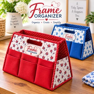 May include: A red fabric organizer with three front pockets, featuring a white floral pattern with red flowers and a red-and-white polka dot trim. An oval label on the front reads Frame ORGANIZER. A blue version with a similar floral design sits behind.
