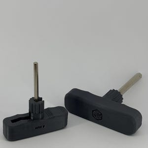 May include: Two black T-handle hex keys with a metallic shaft. One tool features the text 4mm printed on the handle, while the other displays a geometric logo on the side. Both tools have a textured grip area near the base of the metal shaft.