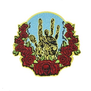 May include: An embroidered patch featuring a black hand with a peace sign gesture, surrounded by red roses and a blue background.