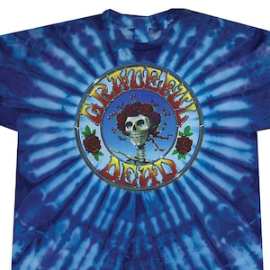 May include: A blue tie-dye t-shirt with a circular graphic of a skull with flowers and the text "Grateful Dead".