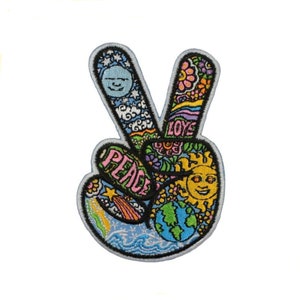 May include: A colorful peace sign patch with a blue background. The patch is embroidered with a variety of designs, including flowers, clouds, stars, a sun, a moon, and the words "Peace" and "Love".