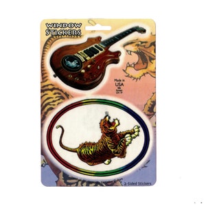 May include: Two-sided window stickers featuring a tiger with a rainbow background and a guitar with a tiger graphic. The stickers are made in the USA and are UV protected.
