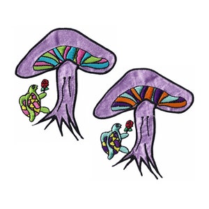 May include: Two embroidered patches featuring a purple mushroom with a colorful cap and a turtle holding a red rose. The mushroom caps have a rainbow design. The turtle has a yellow and purple shell.