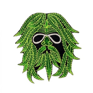 May include: Green embroidered patch of a face with a leafy beard and hair, wearing sunglasses. The face is black with white outlines.