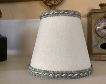 Linen cream chandelier lampshade finished with a french blue with a hint of antique gold and cream scroll gimp trim.