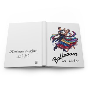 May include: An open hardback book with white pages. The left page features the text "Ballroom is Life! 2026" in black script. The right page displays a colourful illustration of a couple dancing, with the text "Ballroom is Life!" below it.