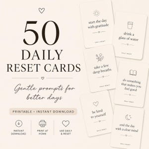 May include: A set of 50 daily reset cards with a cream background and black text. The cards feature prompts like start the day with gratitude, drink a glass of water, take a few deep breaths, do something that makes you feel good, be kind to yourself, and end the day with a clear mind.
