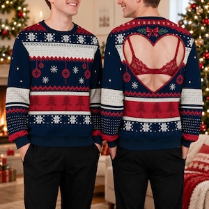 May include: A navy blue, red, and white long-sleeve festive jumper featuring a pattern of snowflakes, pine trees, and hanging ornaments. The back of the jumper has a large heart-shaped cutout revealing a red lace bra underneath.