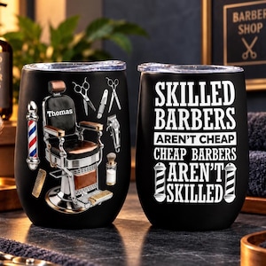May include: Two black stainless steel tumblers with clear lids. One features a vintage barber chair with the name Thomas, scissors, a comb, and a barber pole. The other displays white text reading SKILLED BARBERS AREN'T CHEAP CHEAP BARBERS AREN'T SKILLED.