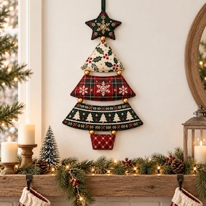May include: A wall-hanging Christmas tree decoration made of five fabric segments in varying patterns, including a dark green star, cream holly print, red plaid with snowflakes, dark green with white trees, and a red diamond-quilted base.
