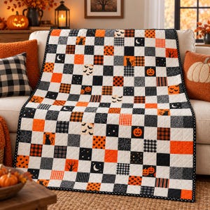 May include: A patchwork quilt featuring a checkerboard pattern of squares in black, white, and orange. The fabric squares display various Halloween-themed prints, including jack-o'-lanterns, black cats, bats, spiderwebs, moons, and plaid patterns.