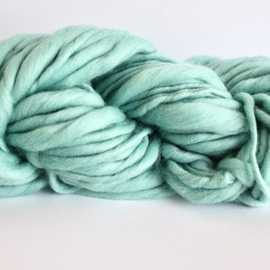 May include: A skein of soft, light blue yarn. The yarn is thick and fluffy, perfect for knitting or crocheting.