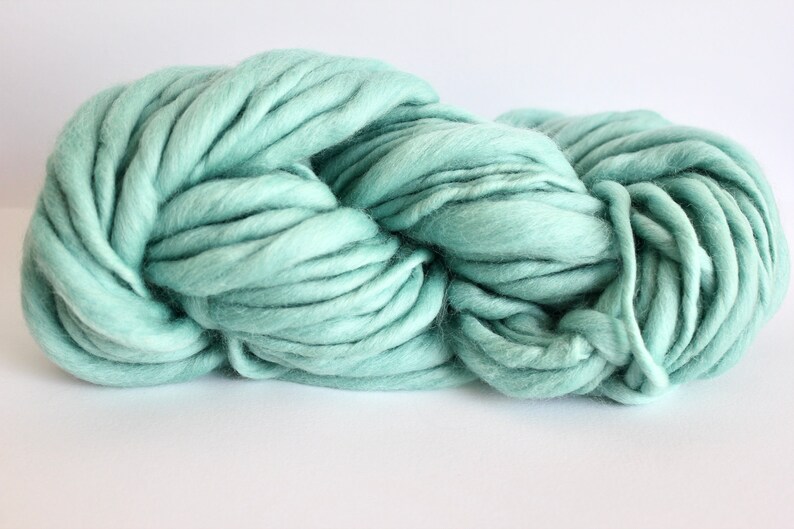 May include: A skein of soft, light blue yarn. The yarn is thick and fluffy, perfect for knitting or crocheting.