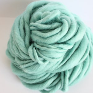 May include: A ball of soft, light blue yarn. The yarn is made of wool and is perfect for knitting or crocheting.