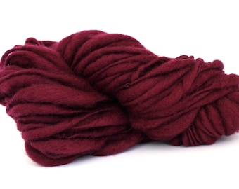 May include: A large ball of deep burgundy yarn, perfect for knitting or crocheting.