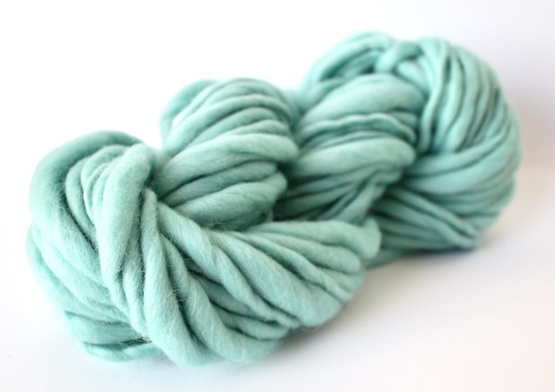 May include: A skein of soft, light blue yarn. The yarn is thick and fluffy, perfect for knitting or crocheting.