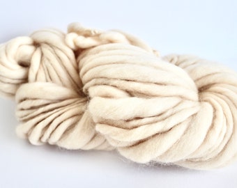 May include: A skein of thick, cream-coloured yarn, ideal for knitting or crocheting chunky projects.