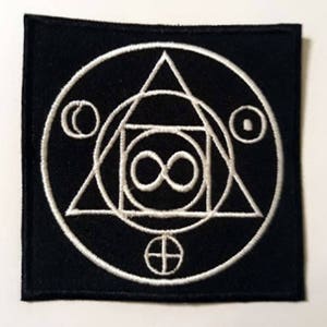 May include: White embroidered patch on a black background featuring a circle with a triangle, square, and infinity symbol inside. The circle also has two small circles and a cross.