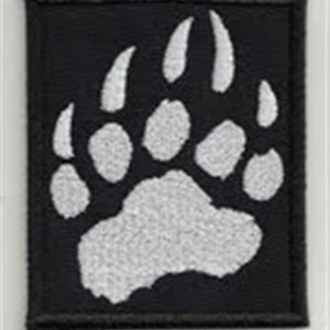 May include: White embroidered bear paw print on a black fabric patch.