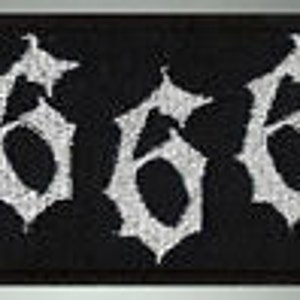 May include: Black and white embroidered patch with the number 666 in a stylized font.