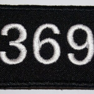 May include: Black fabric patch with white embroidered numbers "369".