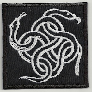 May include: White embroidered snake design on a black fabric patch. The snake is curled in a knot with its tail in its mouth.
