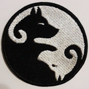 May include: Black and white embroidered patch featuring a yin yang symbol with a wolf silhouette on each side.