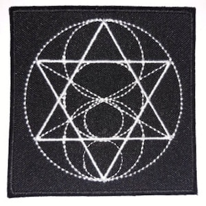 May include: A black fabric patch with a white embroidered geometric design. The design features a star with overlapping circles and triangles.