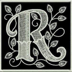 May include: White embroidered letter R with a decorative floral design on a black background.