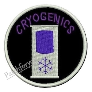 May include: A round, white-bordered patch with a black background. The text "CRYOGENICS" is written in purple around the edge of the patch. In the centre of the patch is a white container with a purple liquid inside and a snowflake on the front.