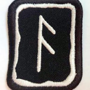 May include: Black square patch with a white embroidered rune symbol. The patch has a white border and a black background. The rune is a stylized, angular design. The patch is likely for clothing or accessories.