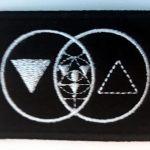 May include: Black embroidered patch with a white design of three overlapping circles. The circles contain a triangle, a circle with a star inside, and another triangle.