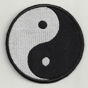 May include: A black and white embroidered yin yang symbol patch. The yin yang symbol is a circular design with two halves, one black and one white, each containing a smaller circle of the opposite color.