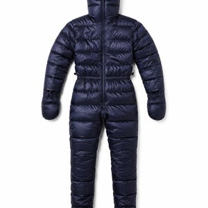 May include: A dark navy blue insulated down jumpsuit featuring a full-length front zipper, an integrated hood with a face opening, long sleeves with attached mittens, and full-length legs with enclosed feet. The garment has a quilted texture.
