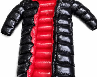 May include: A long, shiny black puffer coat featuring a vibrant red interior lining. This quilted, hooded garment has a full-length front opening, long sleeves, and a high-gloss finish that creates a distinct contrast between the black exterior and red inner.