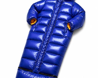 May include: A shiny royal blue insulated sleeping bag with a hood and long sleeves. The interior lining is a bright golden yellow. The garment features a full-length vertical front zip and a horizontal zip across the lower section.