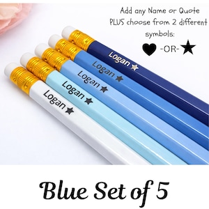 May include: A set of five blue pencils, each with a different shade of blue. Each pencil is personalized with the name "Logan" and a star symbol. The pencils have gold-colored metal bands and white erasers. Text on the image reads "Add any Name or Quote PLUS choose from 2 different symbols: -OR-" and "Blue Set of 5".