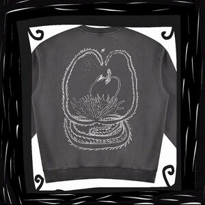 May include: A charcoal gray crewneck sweatshirt featuring a white line art illustration on the back. The graphic depicts a large, spiky carnivorous plant with long, curved leaves and a smaller plant in the center, accompanied by a tiny flying insect.