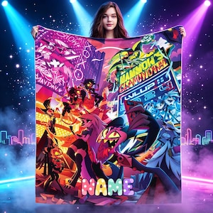 May include: A rectangular fleece blanket featuring a vibrant, multi-colored graphic print of various animated characters in a neon-lit city setting. The design includes bold text elements like "MAMMON'S CLAM" and "NAME" in large, colorful, polka-dotted letters.